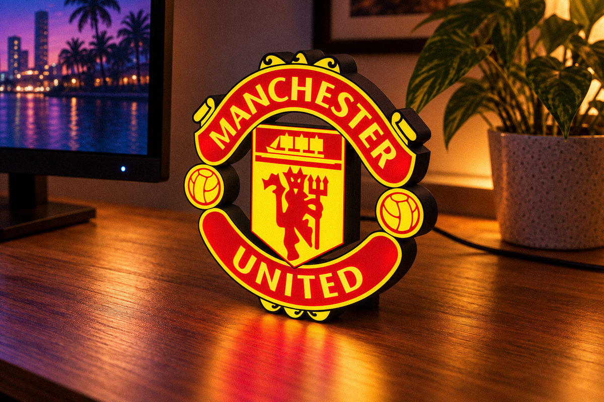 Manchester United red and yellow illuminated LED crest displayed on gaming desk