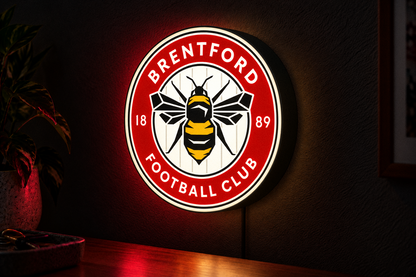 Brentford FC illuminated football crest lightbox mounted on a dark wall